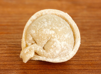 Raw Dumpling on wooden background close-up