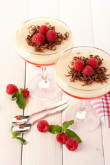 fruit jelly with berries in glasses on wooden table