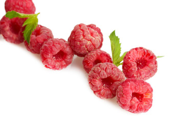 ripe raspberries with mint  isolated on white