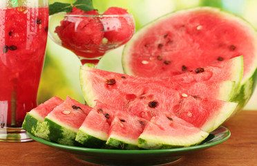 Refreshing desserts of watermelon on green background close-up
