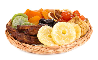Dried fruits on wicker plate isolated on white