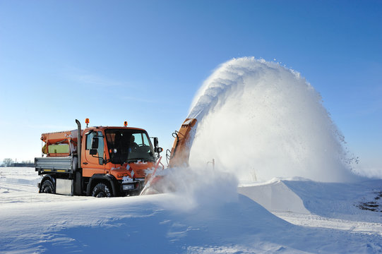 snow blow cleaning road