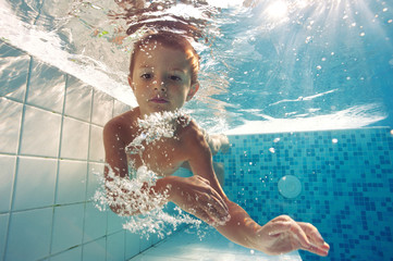 Underwater little kid close up portrait.