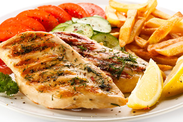 Grilled steaks, French fries and vegetables