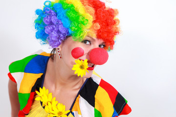 Clown looking to the copy space area in a white studio