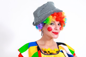 Clown looking to the copy space area in a white studio