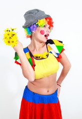 Clown looking to the copy space area in a white studio