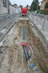 road excavation at a construction site at conduits for the layin
