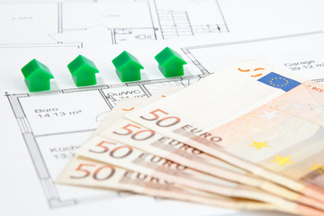 Häuser mit Bauplan und Banknoten