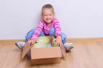 Little girl with dishware