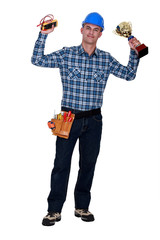 electrician holding a measurement tool and a golden cup