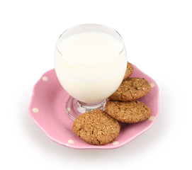 glass of milk and whole grain cookies in a ping plate