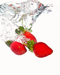 Three strawberries falling