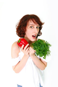 Amazed young woman with vegetables isolated on white background