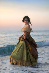 beautiful girl in a vintage dress at the sea
