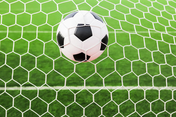 Fototapeta na wymiar soccer ball in the goal net