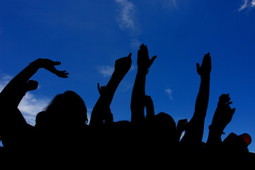 crowd with raised hands