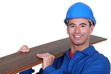 Man holding laminate floor panel
