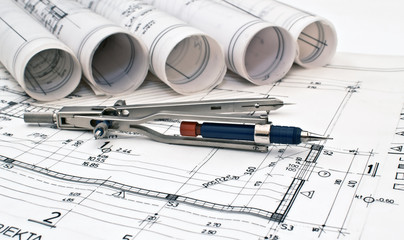 heap of design and project drawings on table background