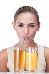 Close-up portrait of happy young woman with juice on white backg