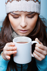 woman in hat with hot tea