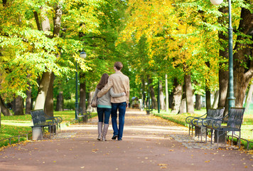 Couple in love walking in park by fall