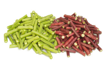 Fresh chopped green and red beans on a white background