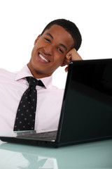 Businessman casually sat at desk