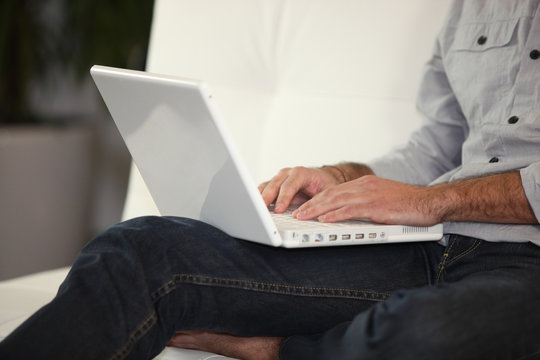 Man typing on a laptop
