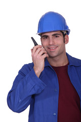 Construction worker speaking into a walkie-talkie