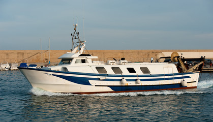 Fototapeta premium The fishing boat returns to port