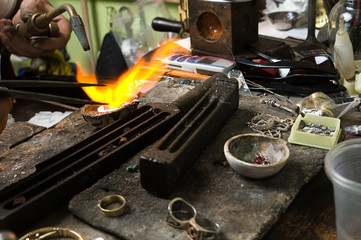 Jeweler melting silver with gasoline burner