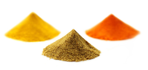 Ground spices over white background