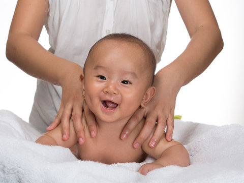 Laughing baby getting massage