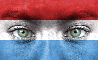 Human face painted with flag of Luxembourg