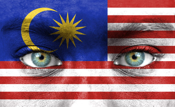 Human face painted with flag of Malaysia