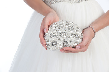 Bride holding white handbag close-up