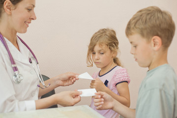 Doctor gives recipe for brother and sister, focus on girl