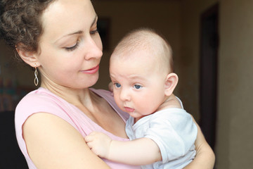 Young mom hold baby in hands