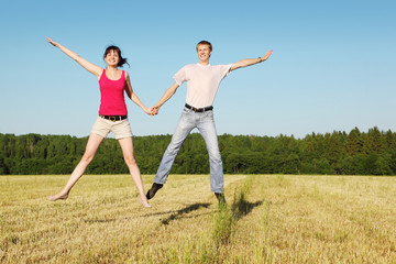 Husband, wife in jump in field