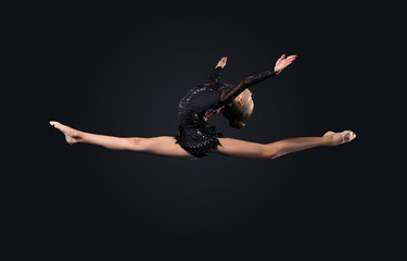 Naklejka premium Young woman in gymnast suit posing