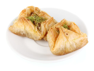 Sweet baklava on plate isolated on white