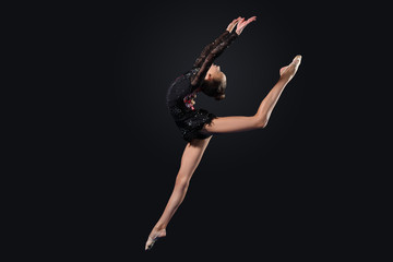 Young woman in gymnast suit posing