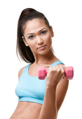 Athletic young woman exercises with pink weights