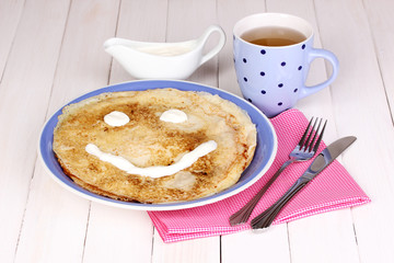 Stack of tasty pancakes on wooden background