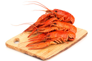 Tasty boiled crayfishes on chopping board isolated on white