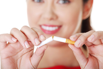 Young woman with broken cigarette.