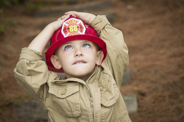 Adorable Child Boy with Fireman Hat Playing Outside