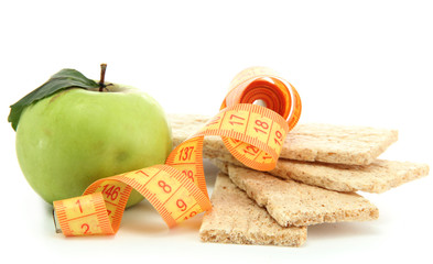 tasty crispbread, apple and measuring tape, isolated on white