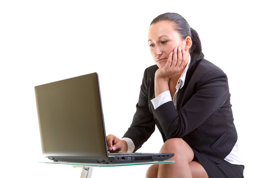 Brunette business woman working on the laptop
